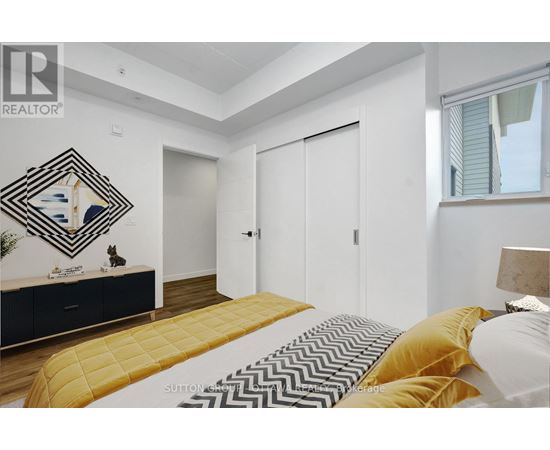 A bedroom with a bed, dresser, and mirror.