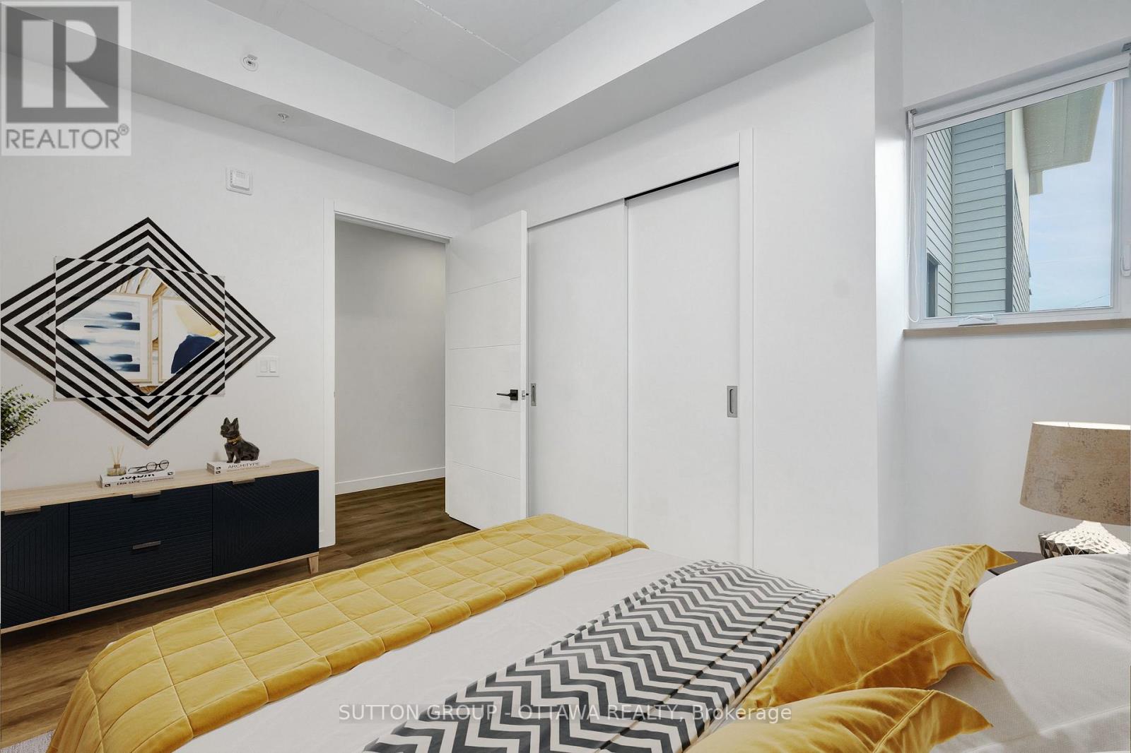 A bedroom with a bed, dresser, and mirror.