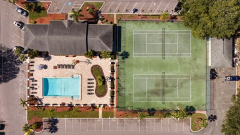 a property with a tennis court and a pool on it