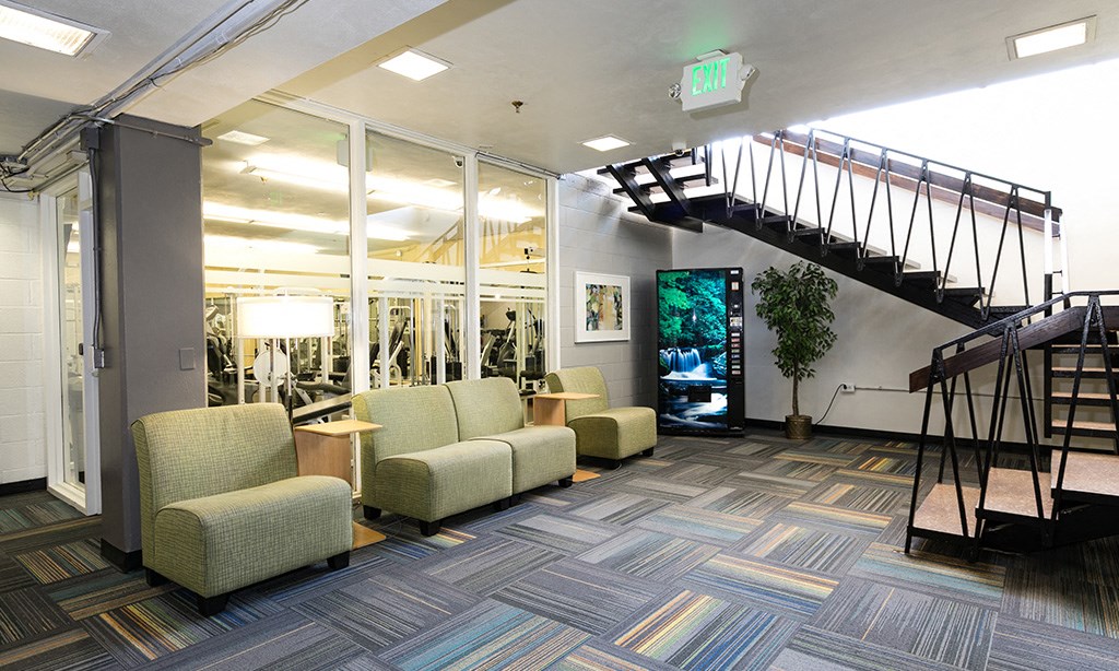 a lobby with couches and chairs and a staircase