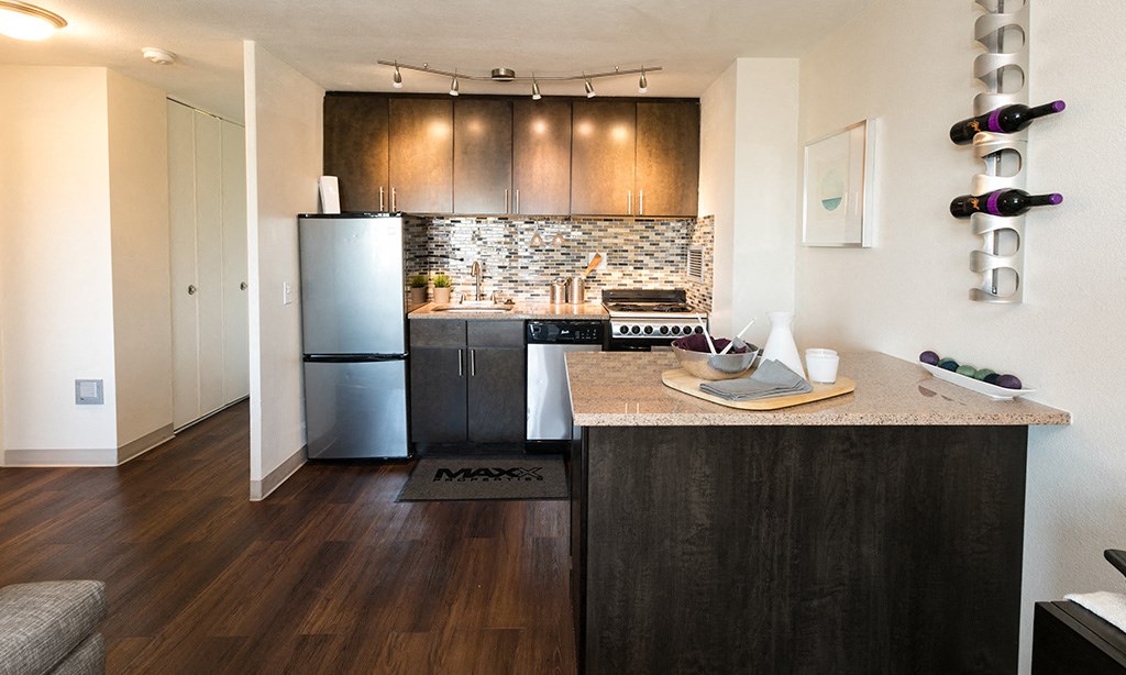 a kitchen with stainless steel appliances and wooden cabinets