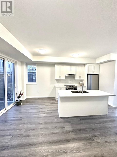 A white kitchen with a large island in the middle.