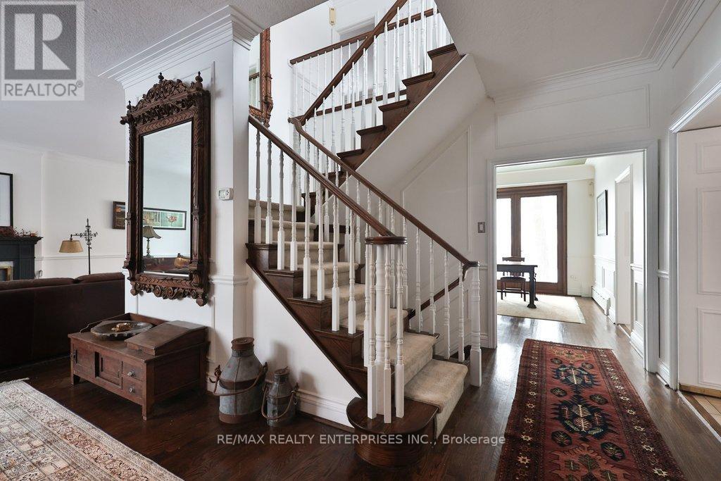 A large mirror hangs above a wooden chest in a spacious room.
