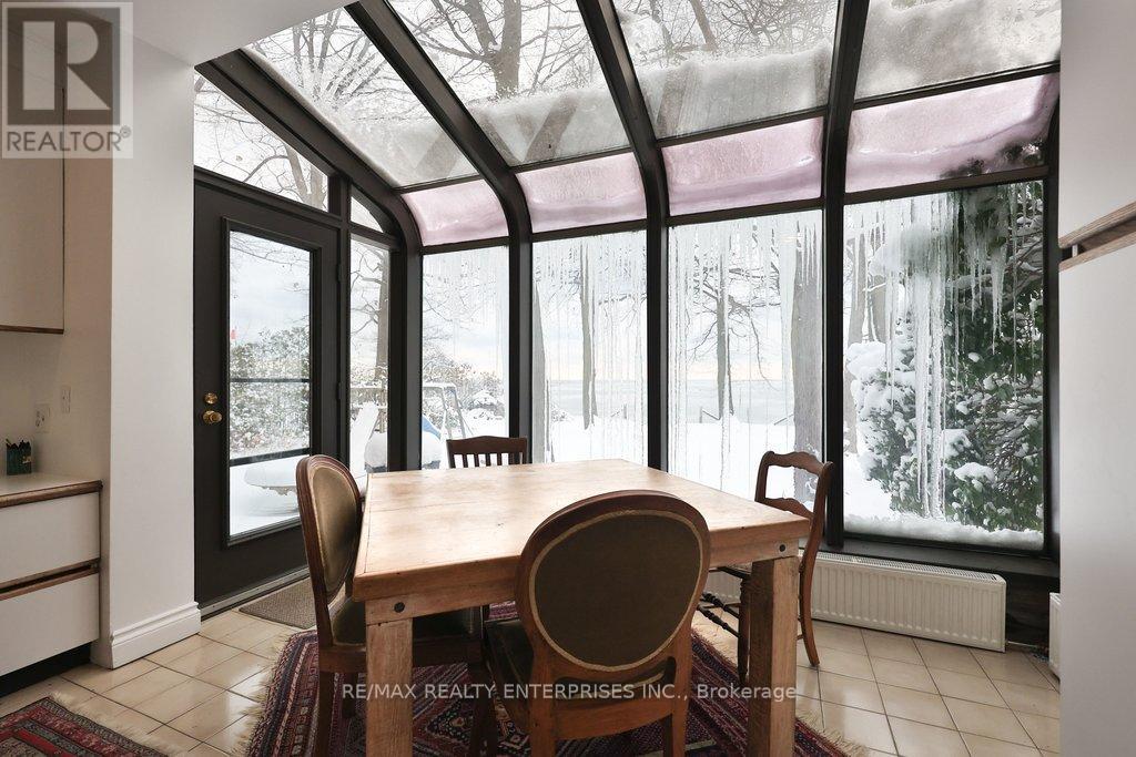 A dining room with a table and chairs and a glass roof.
