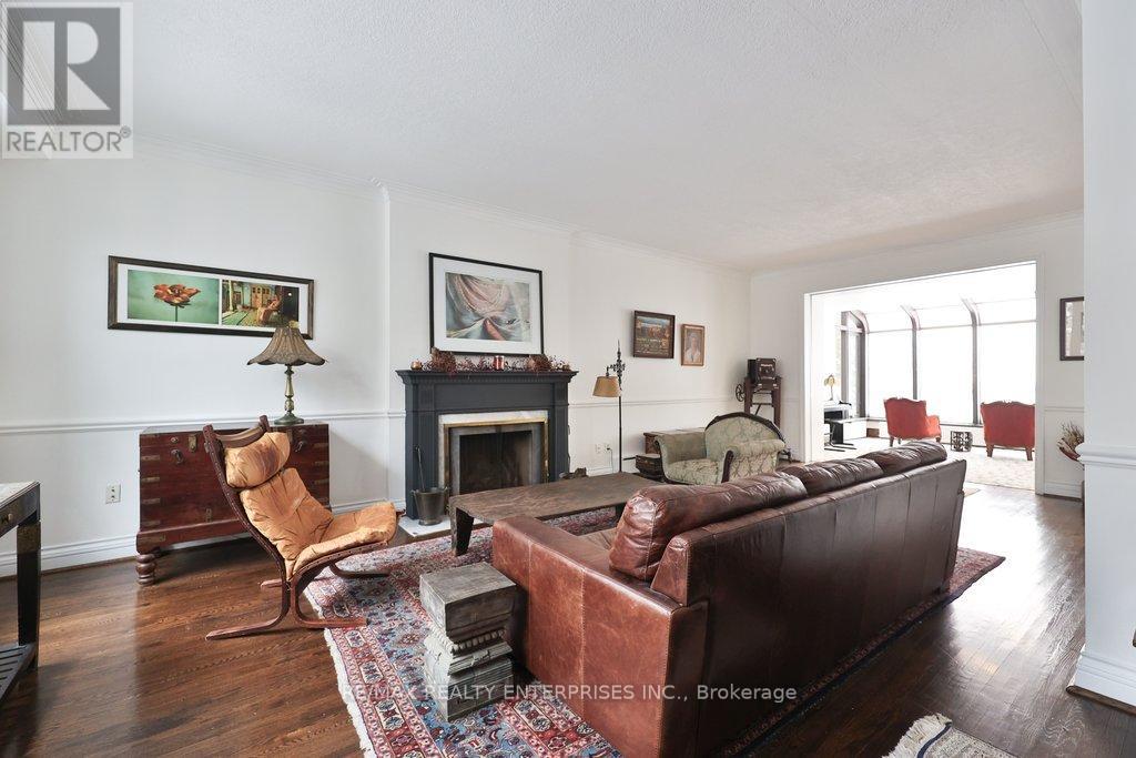 A living room with a brown couch and a fireplace.