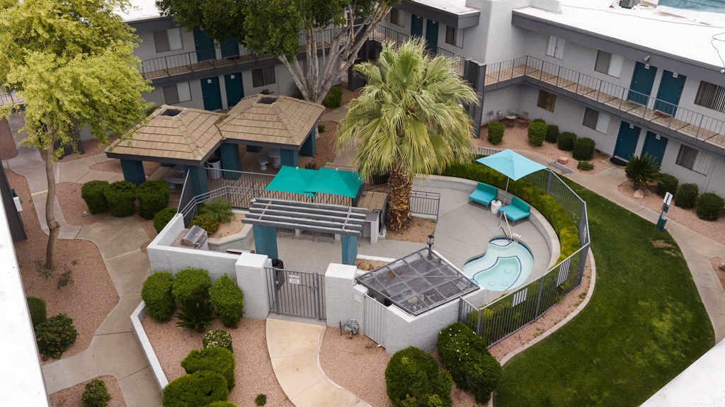 an aerial view of a swimming pool in the courtyard of an apartment building