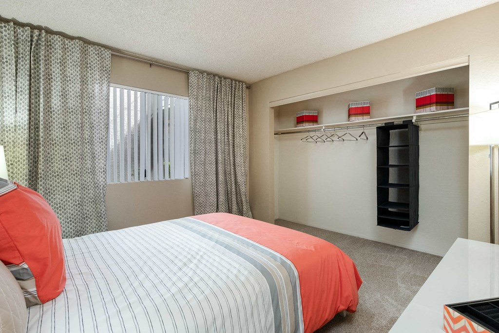 a bedroom with a bed and a window and a closet