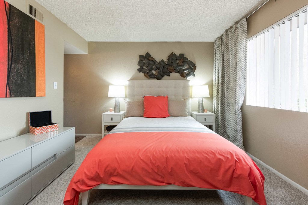 a bedroom with a bed and a large window