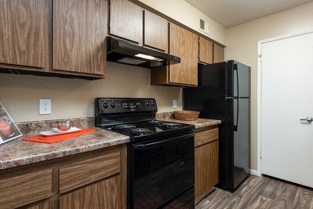 a kitchen with black appliances and a black refrigerator