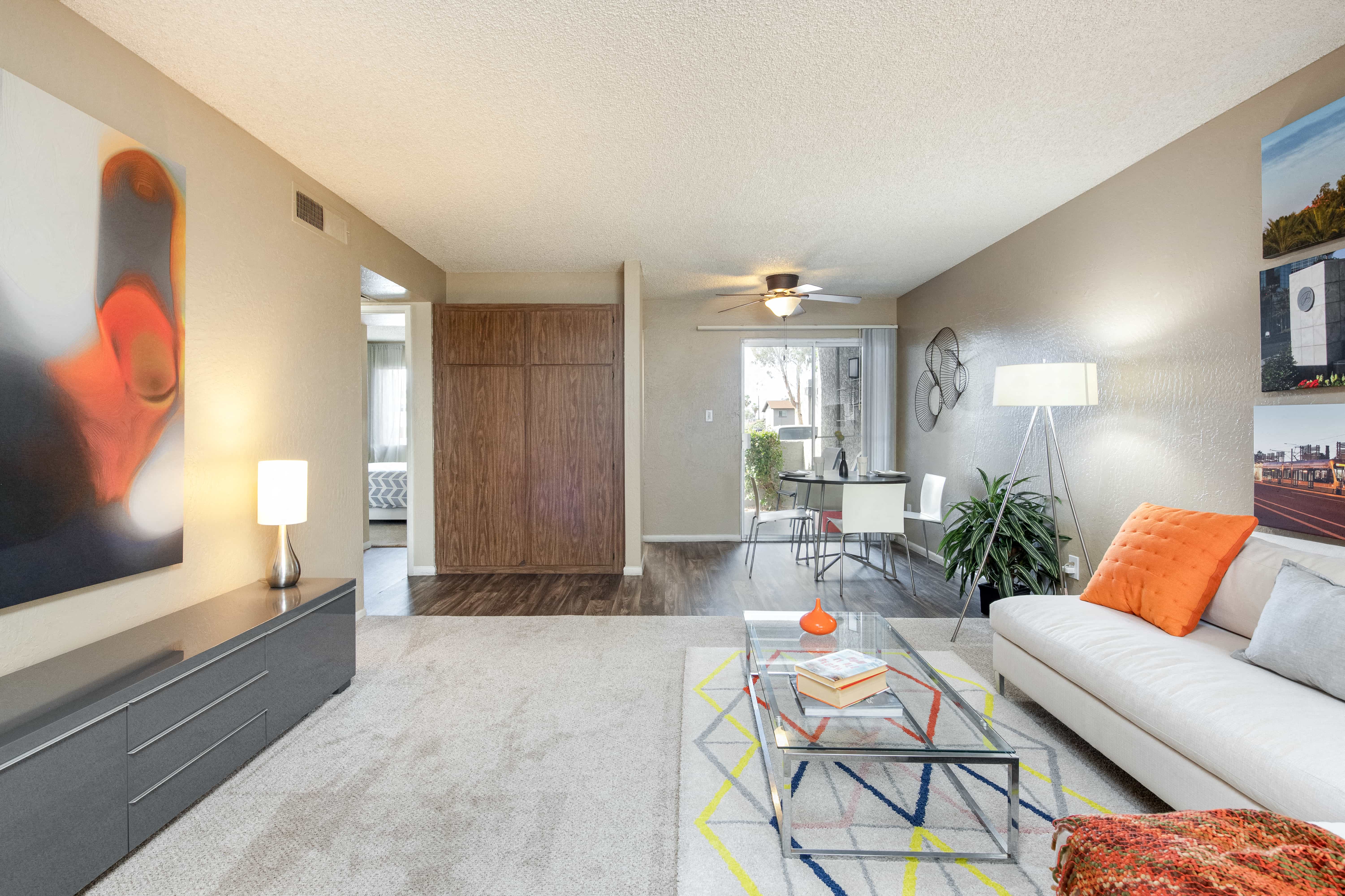 a living room with a white couch and a glass table