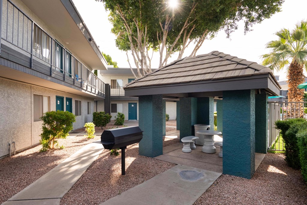 a courtyard with a grill and a toilet in front of a building