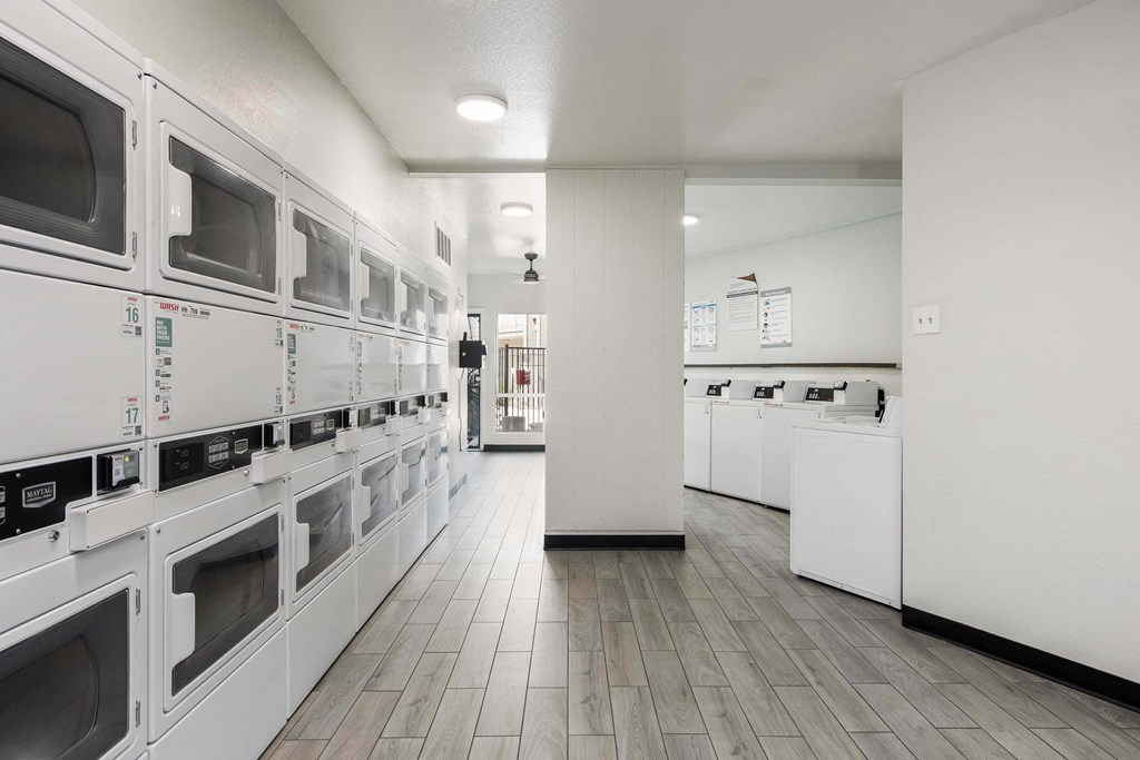 a laundromat with rows of microwaves on the wall