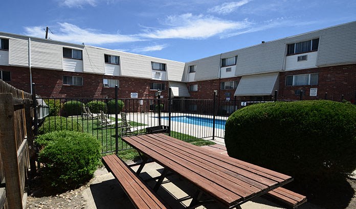 a picnic table sitting in front of a pool