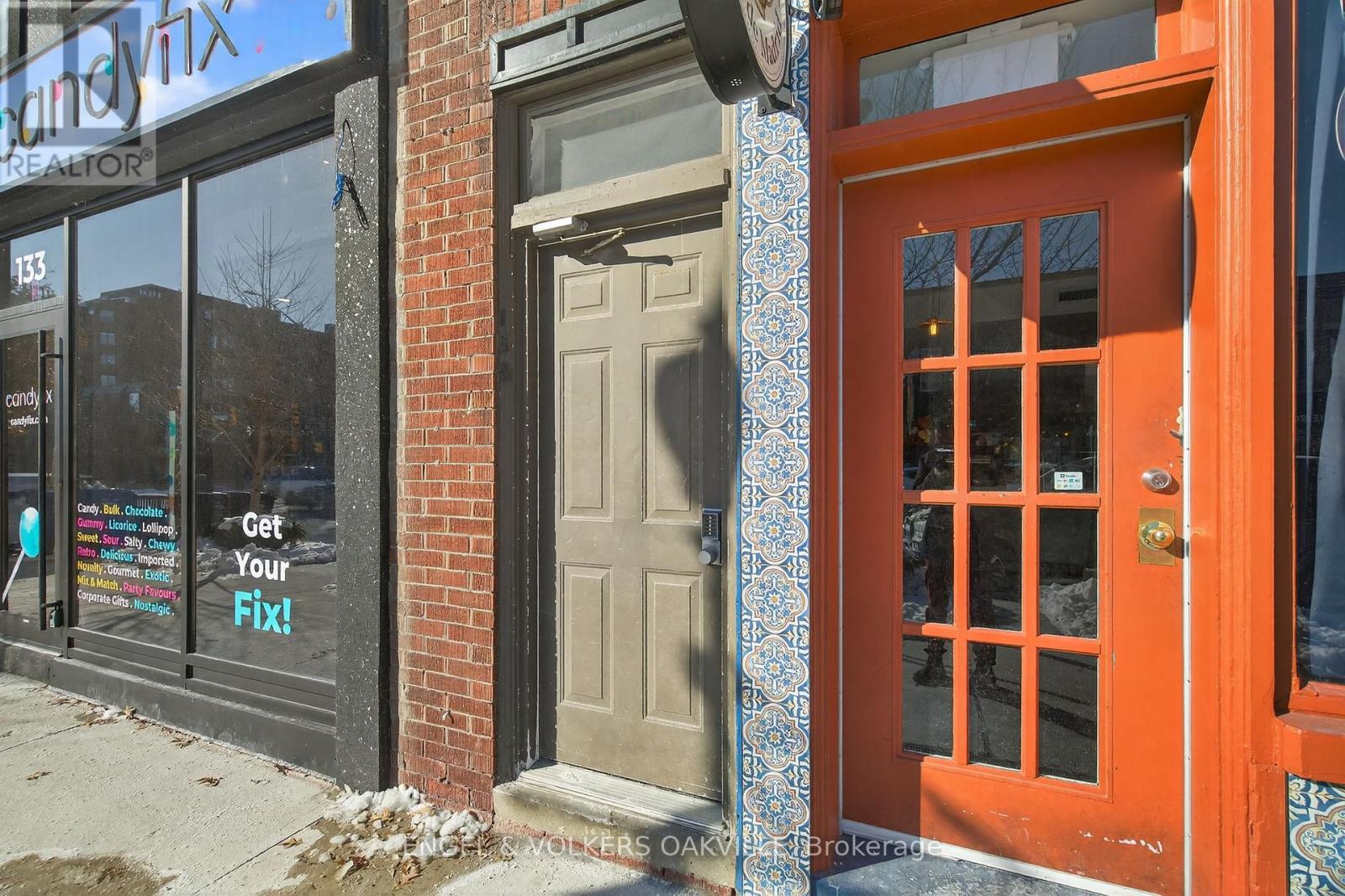 A red door with a glass window is on the right side of the image.