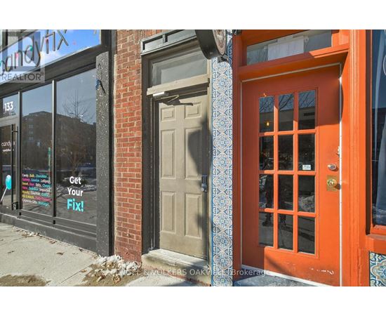 A red door with a glass window is on the right side of the image.