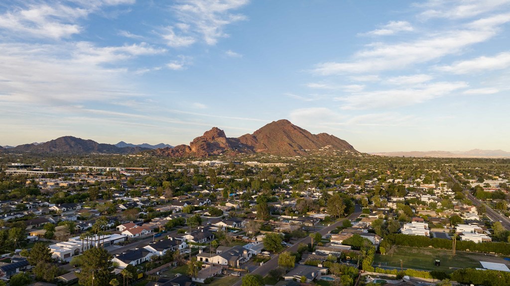 an aerial view of a city with mountains in the background