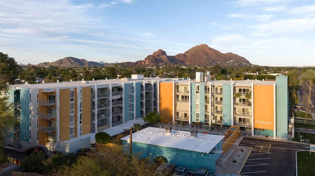 an aerial view of an apartment building with mountains in the background