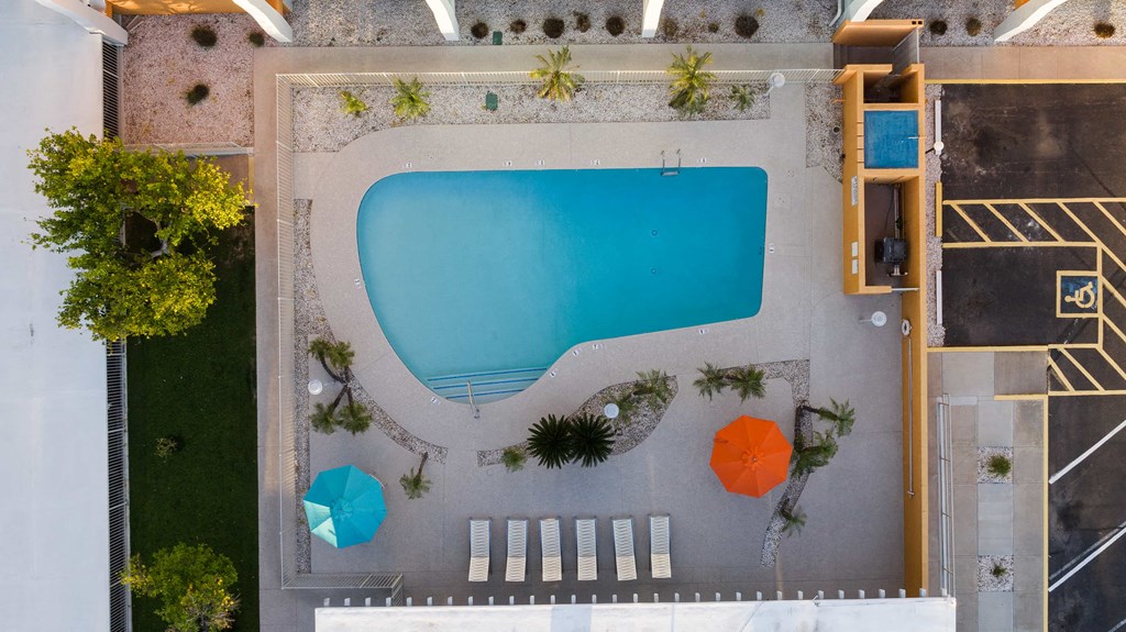a birds eye view of a swimming pool with umbrellas