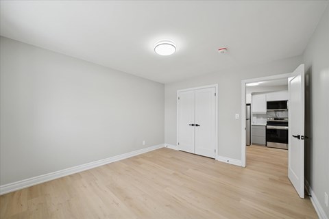 A room with a white door and a white cabinet.