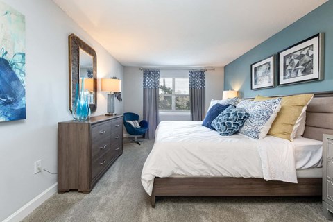 a bedroom with a bed and a dresser