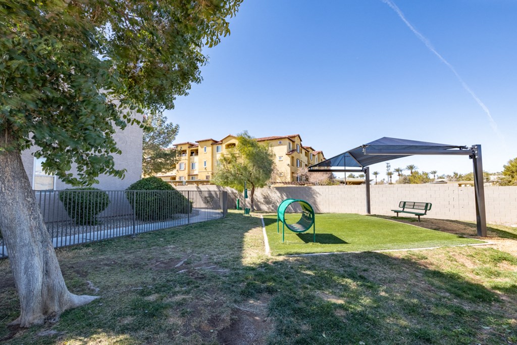 a backyard with a gazebo and a tree with a swing