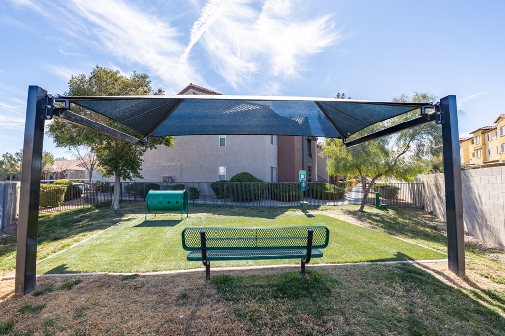 a park with a bench and a canopy