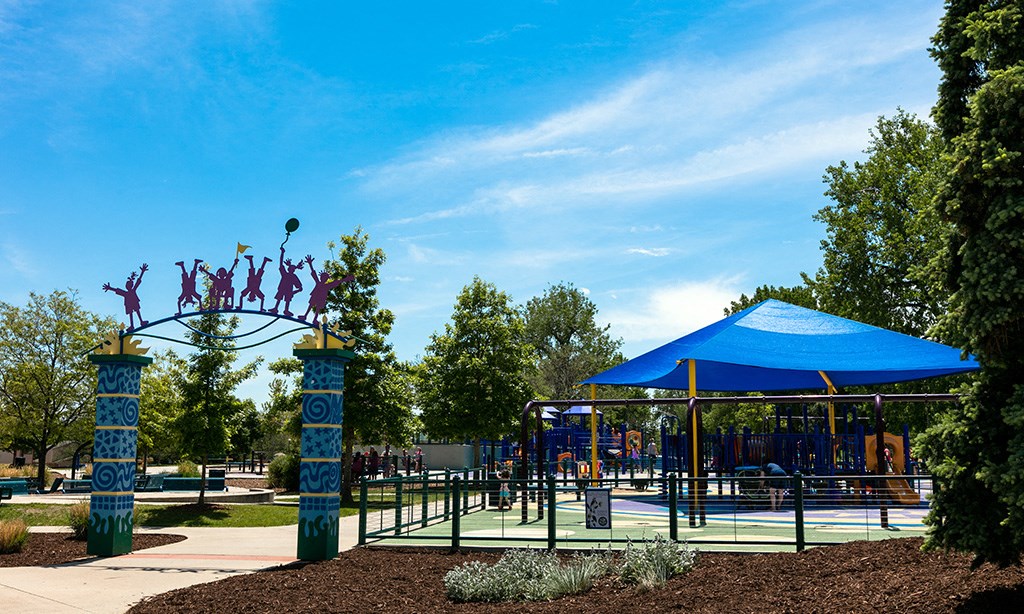 a playground with a blue pavilion and a blue sky