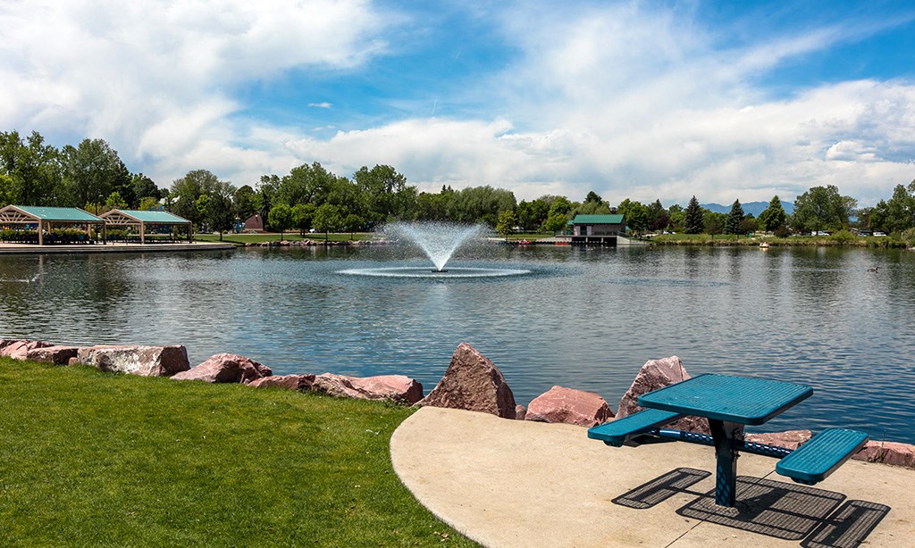 a park with a fountain in the middle of a lake