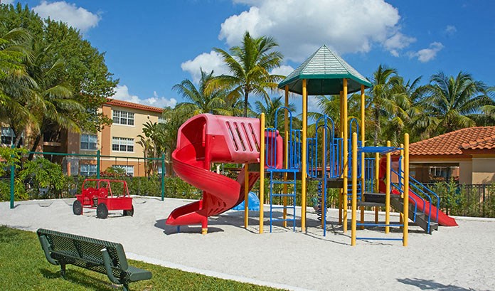 a playground with a red slide and a red  slide