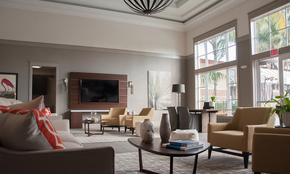 a living room with couches and chairs and a television