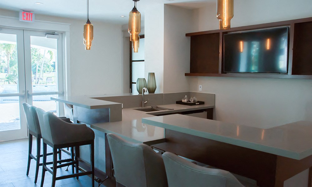 an open kitchen and dining area with modern furniture and a tv