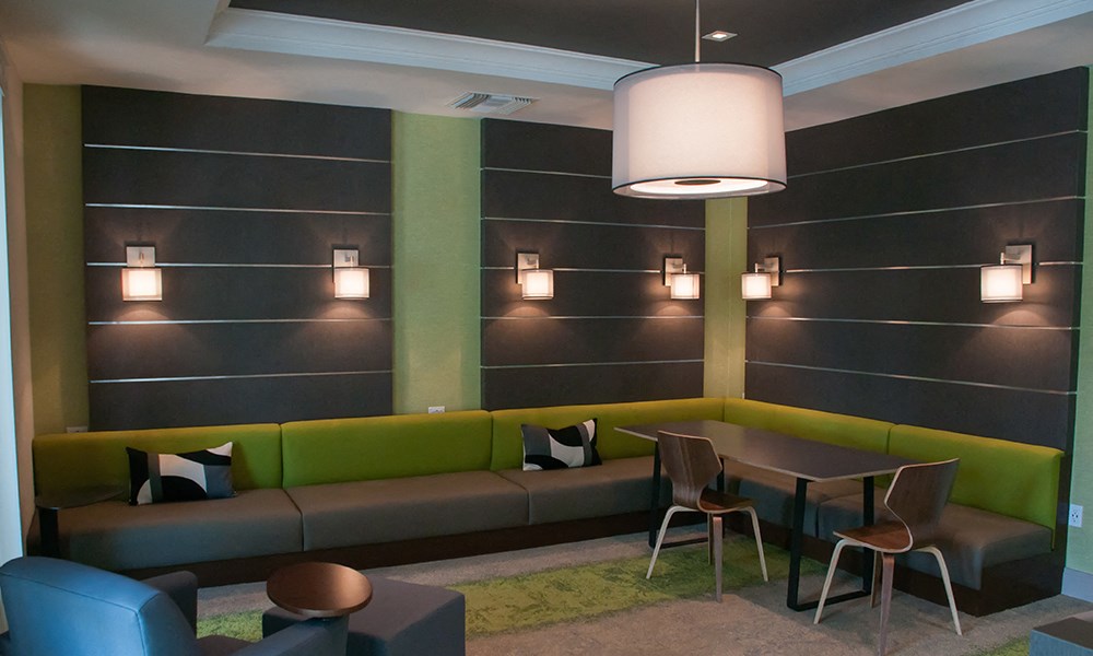 a lounge area with a table and couches and chairs