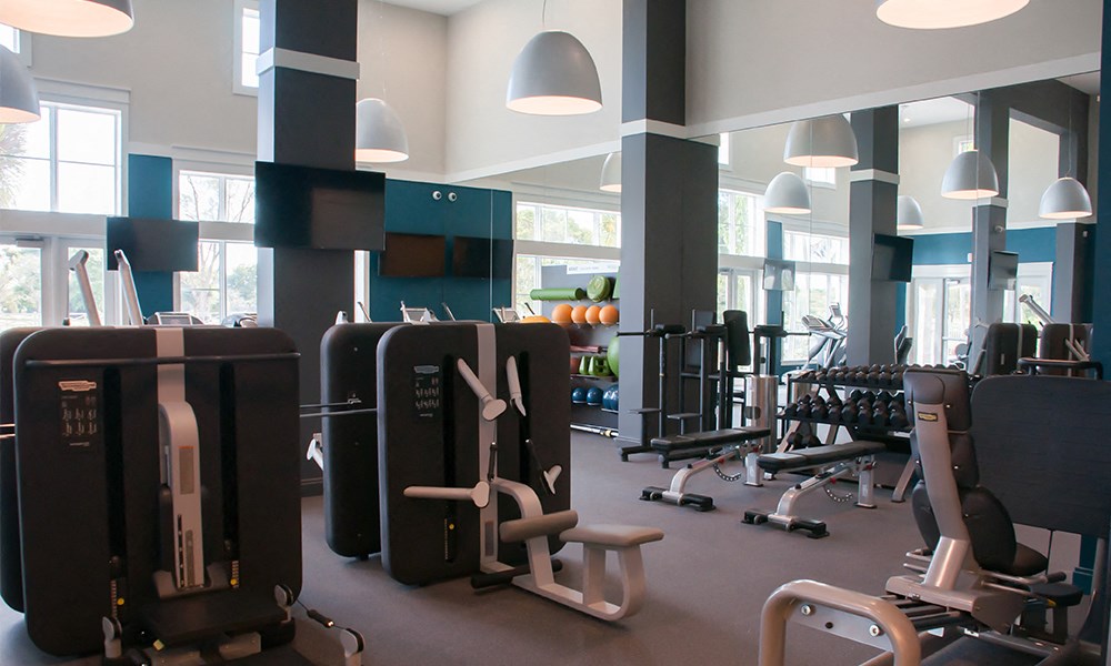 a room with suitcases and weights and other exercise equipment in a gym