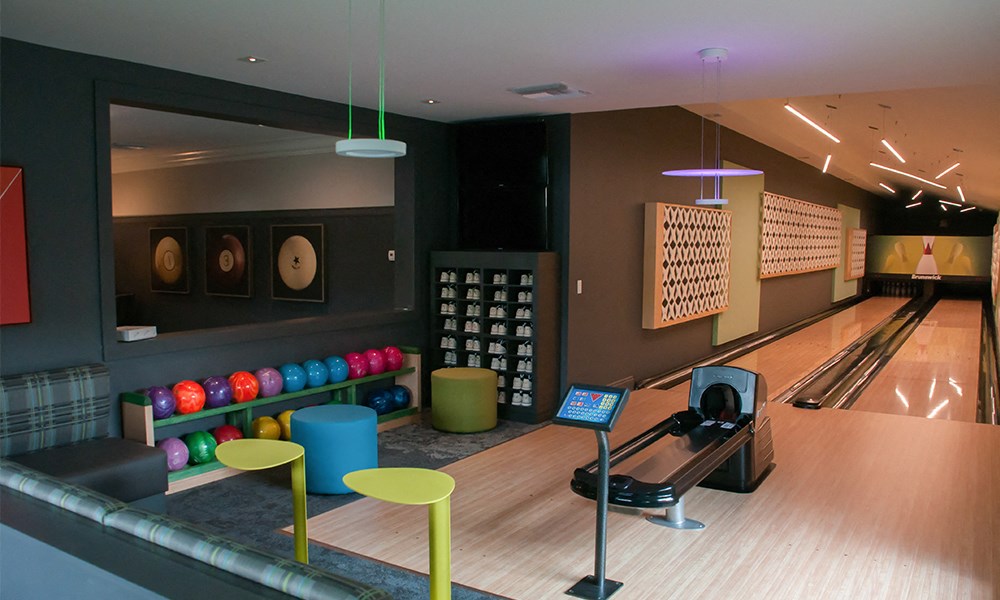 a bowling alley in a bowling club with bowling balls on the wall