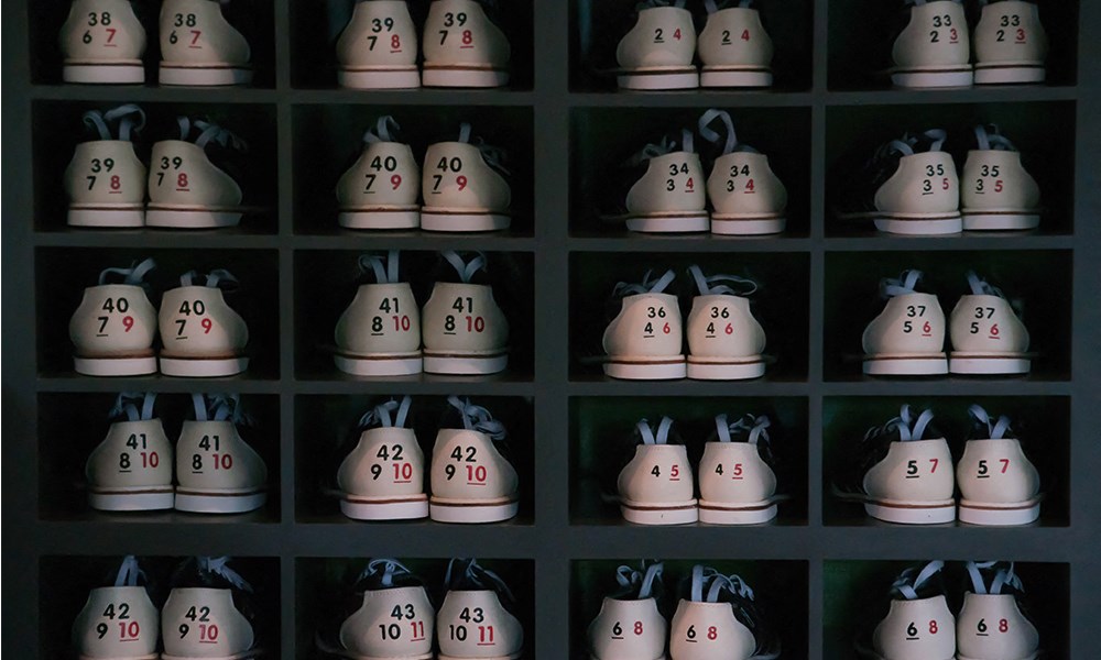 a collection of white shoes with numbers on them in a black box