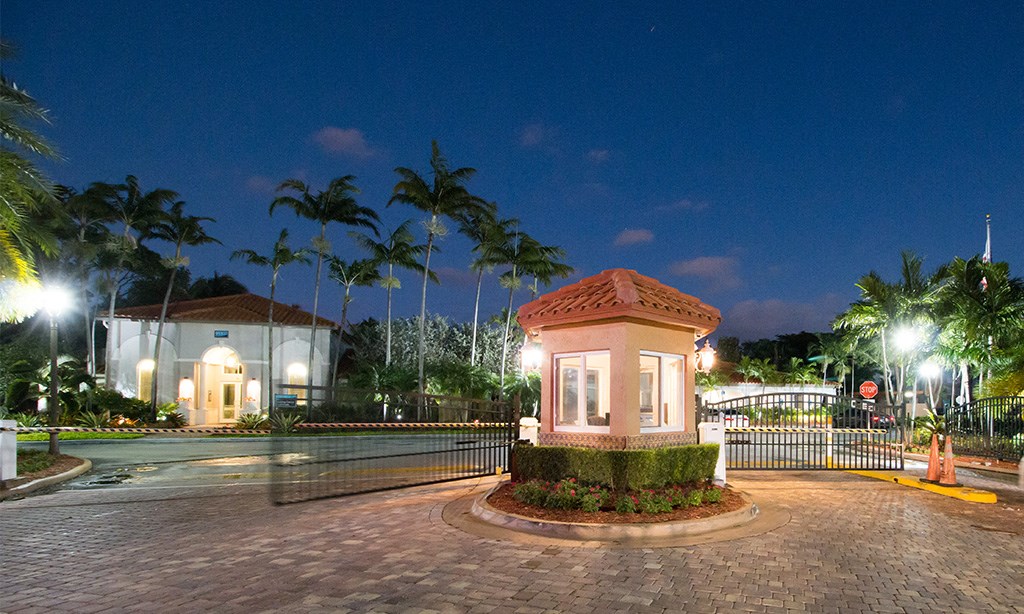 a city at night with palm trees and a building