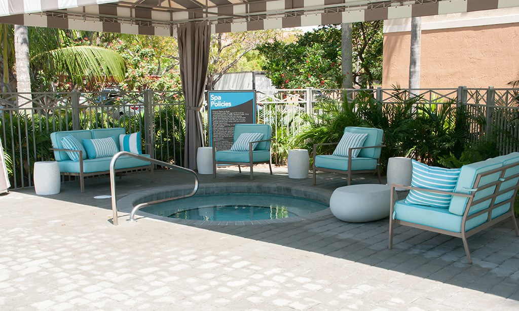 a small pool with blue chairs and chairs around it