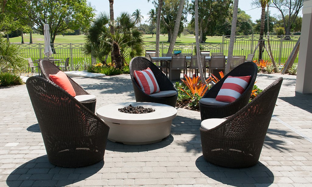 a group of chairs sitting around a fire pit on a patio