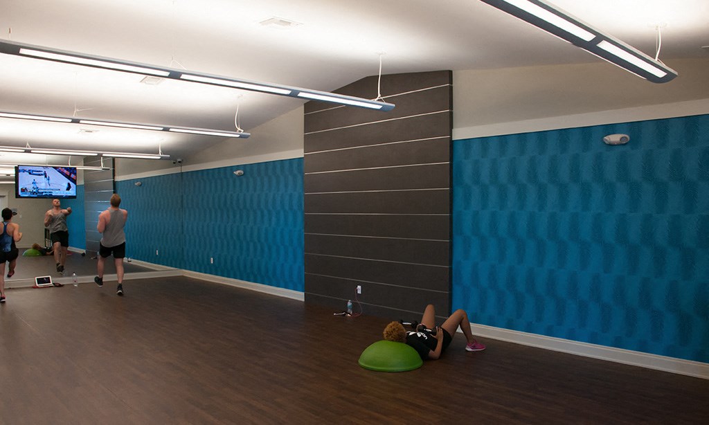 a large room with a blue wall and a person laying on the floor