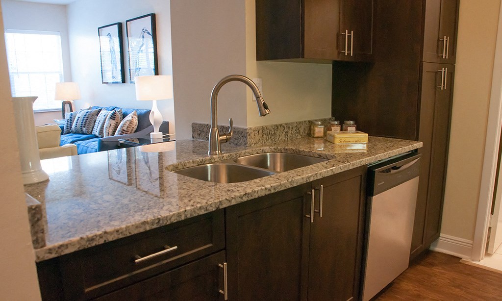 a kitchen with granite counter tops and a sink