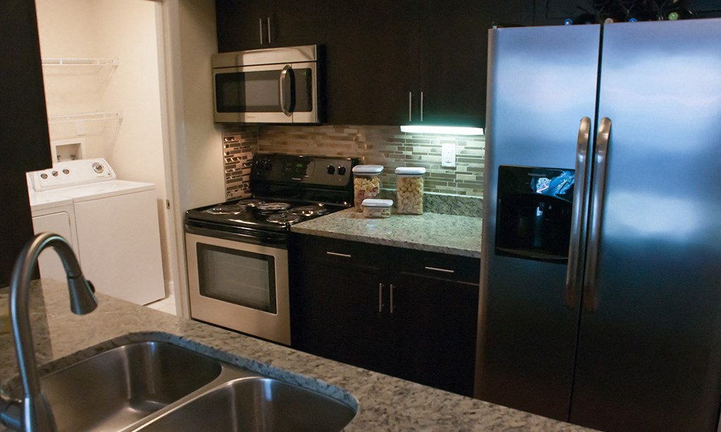a kitchen with stainless steel appliances and granite counter tops