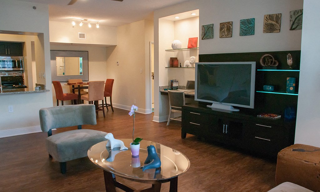 a living room and dining room with a tv and a table