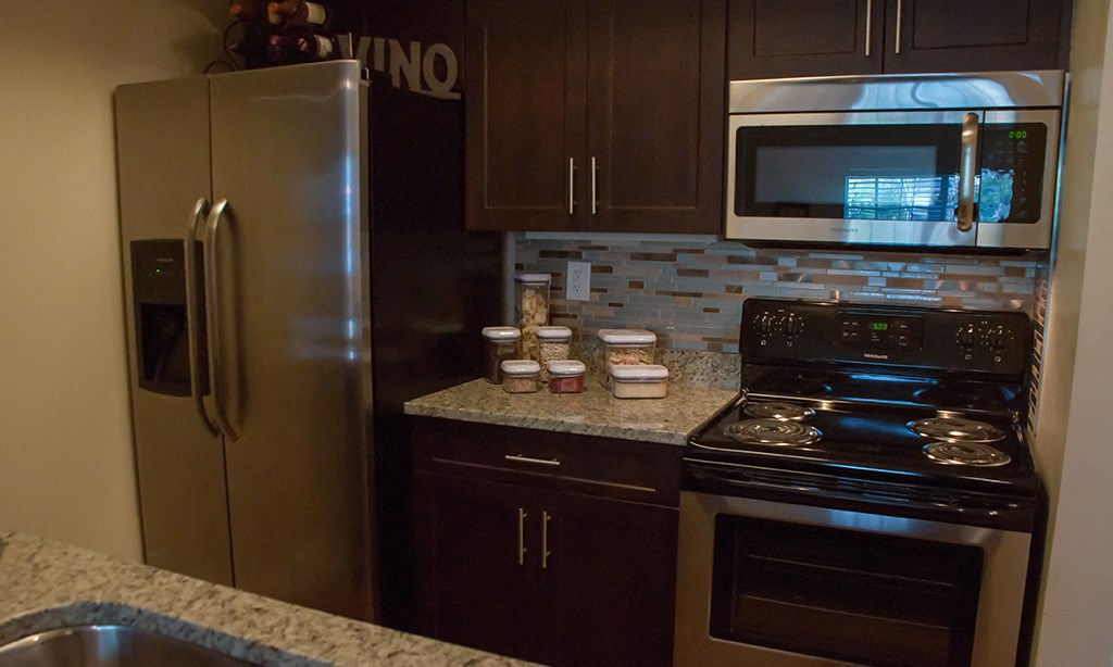 a kitchen with stainless steel appliances and granite counter tops