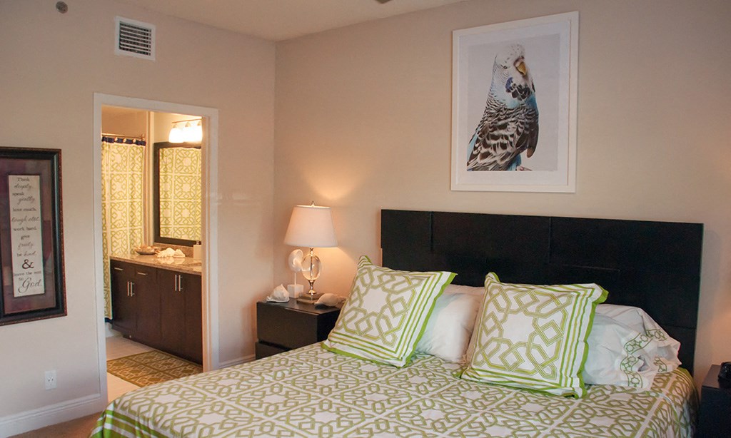 a bedroom with a bed and a bathroom with a sink