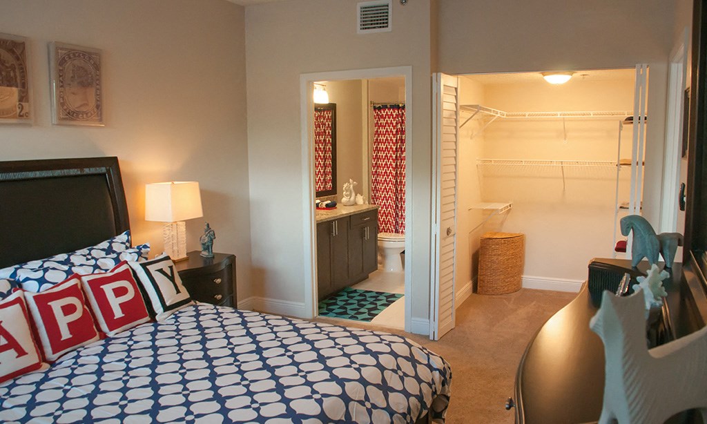 a bedroom with a bed and a bathroom with a shower