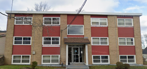 A red and beige building with the number 8224 on the front door.