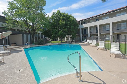 our apartments have a swimming pool and a patio with chairs