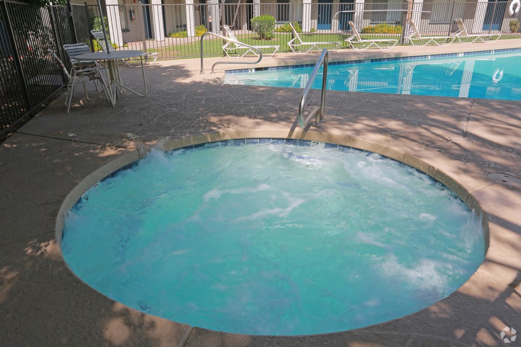 a hot tub in the middle of a resort pool