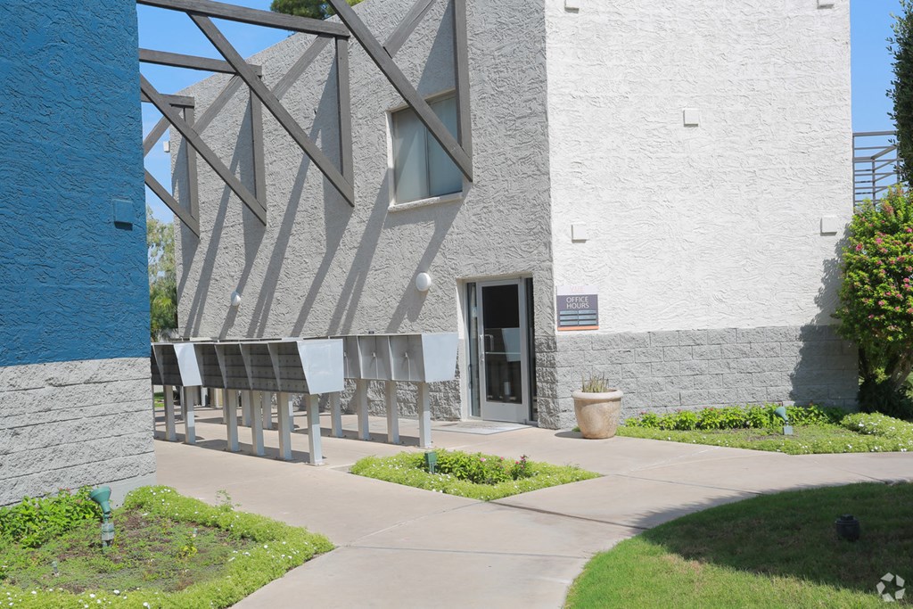 the outside of a building with a sidewalk and a door