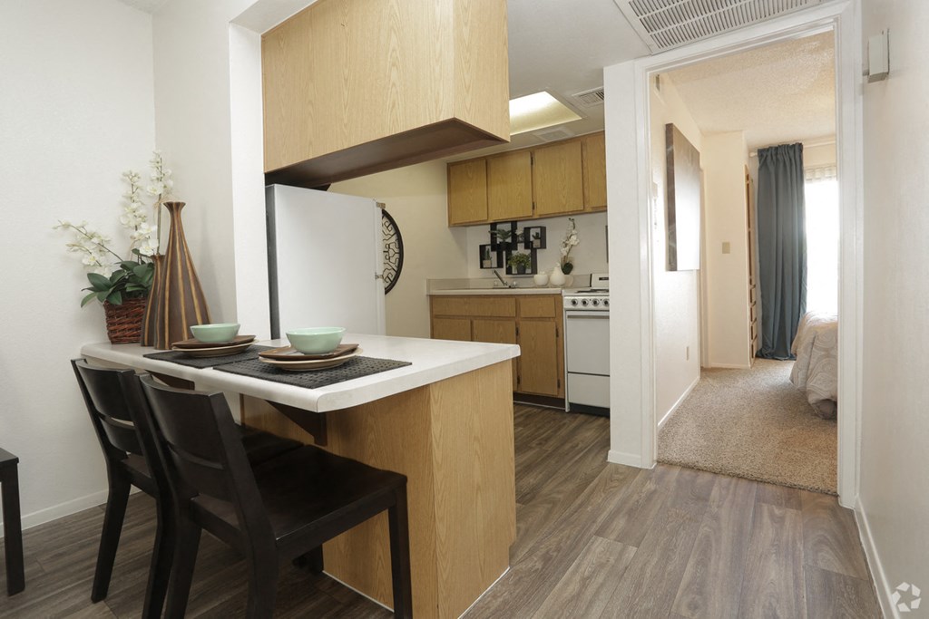 a kitchen and dining area with a table and chairs in an apartment